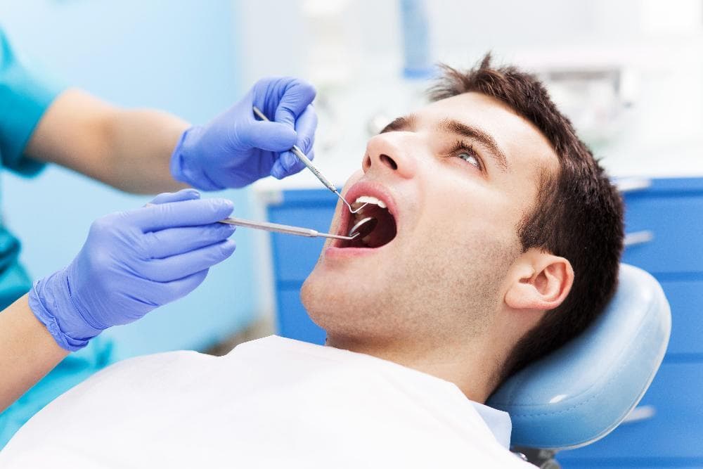 Orlando dentist providing gentle dental care to a patient in the chair